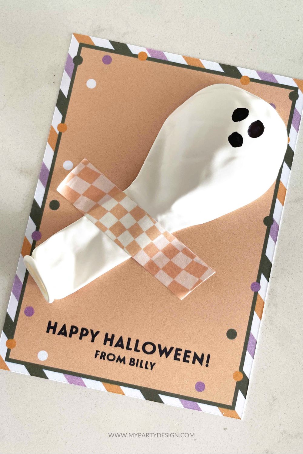 white balloon with ghost face for an easy halloween class gift