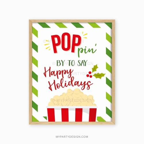 green and red popcorn christmas holidays sign that reads "poppin by to say happy holidays"